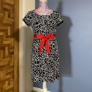 Black & white festive dress with beautiful red satin bow belt.